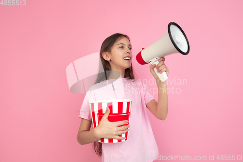 Image of Caucasian little girl portrait isolated on pink studio background, emotions concept