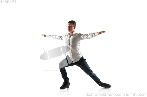 Image of Man figure skating isolated on white studio backgound with copyspace