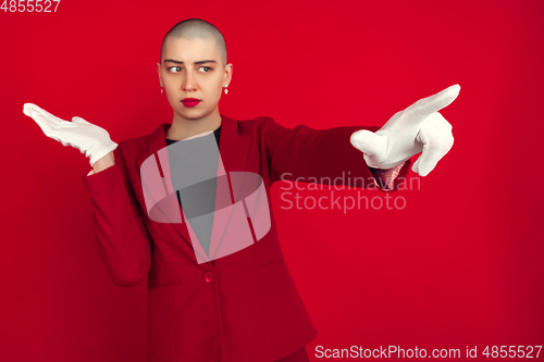 Image of Portrait of young caucasian bald woman on red background