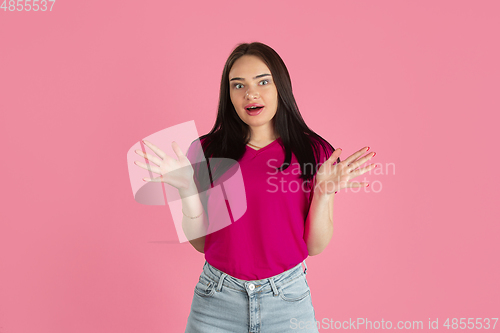 Image of Monochrome portrait of young caucasian brunette woman on pink background