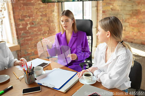 Image of Business young caucasian woman in modern office with team