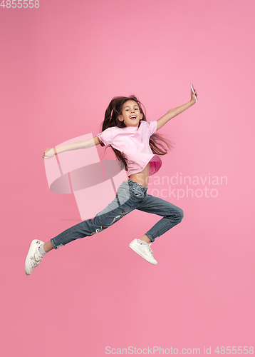 Image of Caucasian little girl portrait isolated on pink studio background, emotions concept