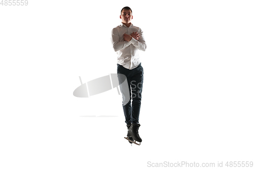 Image of Man figure skating isolated on white studio backgound with copyspace