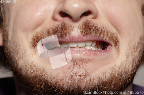 Image of Close-up male mouth illustrating emotions. Cosmetology, dentistry and beauty care, facial expression
