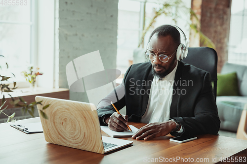 Image of Businessman or student working from home while being isolated or keep quarantine \'cause of coronavirus COVID-19