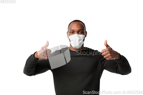 Image of How coronavirus changed our lives. Young man wearing face mask to stop spreading on white background