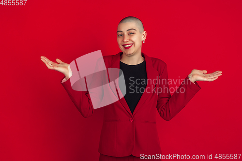 Image of Portrait of young caucasian bald woman on red background