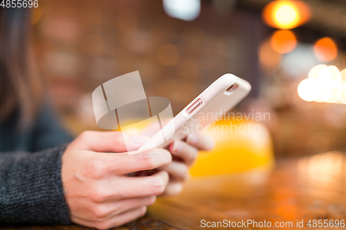 Image of Woman sending sms on cellphone