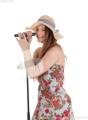 Image of Woman standing holding microphone