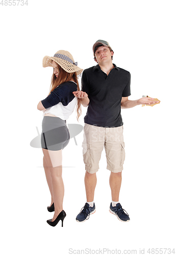 Image of Young couple arguing, standing helpless