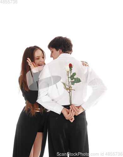 Image of Man surprising girlfriend with red rose