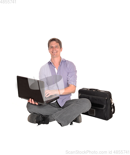 Image of Man sitting on floor with his laptop