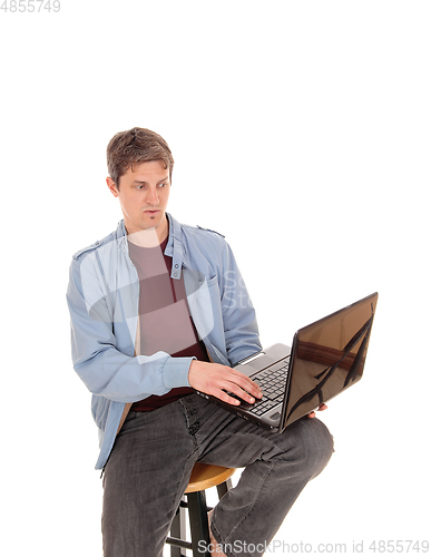 Image of Suspicion man looking at the screen of his laptop