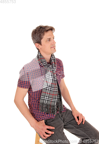 Image of Relaxed young man sitting on chair