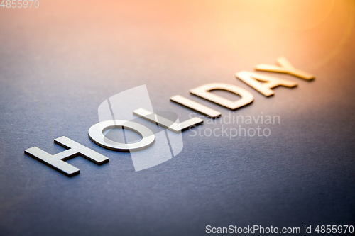 Image of Word holiday written with white solid letters