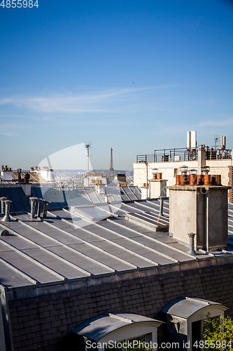 Image of The traditional roofs of paris and the eiffel tower