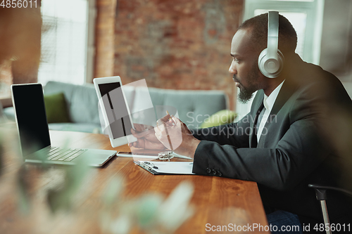 Image of Businessman or student working from home while being isolated or keep quarantine \'cause of coronavirus COVID-19