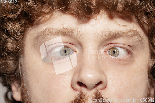 Image of Close up of face of beautiful caucasian young man, focus on eyes