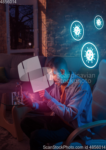 Image of Shocked, upset and sad man using gadgets to get information of coronavirus pandemic spread