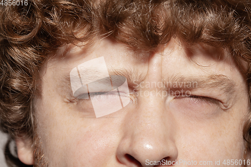 Image of Close up of face of beautiful caucasian young man, focus on eyes