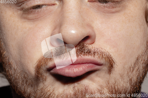 Image of Close-up male mouth illustrating emotions. Cosmetology, dentistry and beauty care, facial expression