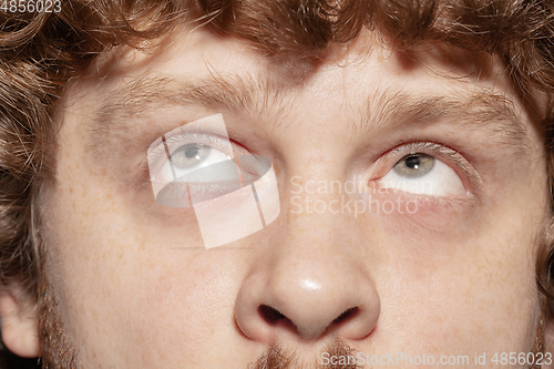 Image of Close up of face of beautiful caucasian young man, focus on eyes