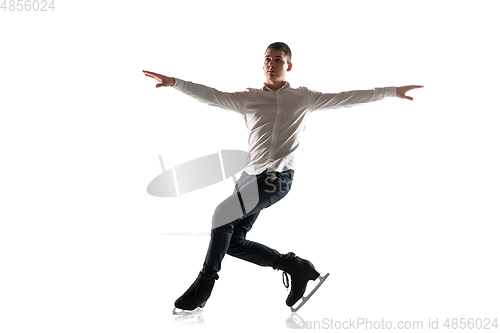 Image of Man figure skating isolated on white studio backgound with copyspace