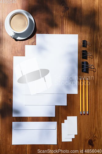 Image of Creative and cozy workplace at home office, inspirational mock up with plant shadows on table surface