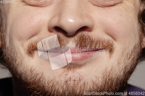 Image of Close-up male mouth illustrating emotions. Cosmetology, dentistry and beauty care, facial expression