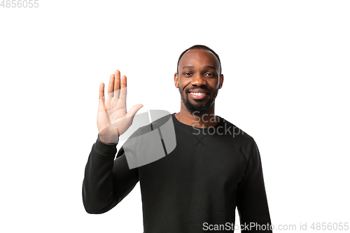Image of How coronavirus changed our lives. Young man greeting on white background