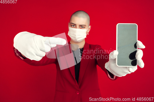 Image of Portrait of young caucasian bald woman on red background