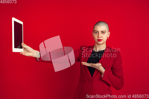 Image of Portrait of young caucasian bald woman on red background