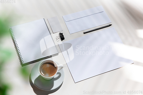 Image of Creative and cozy workplace at home office, inspirational mock up with plant shadows on table surface