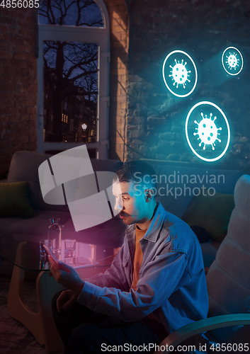 Image of Shocked, upset and sad man using gadgets to get information of coronavirus pandemic spread