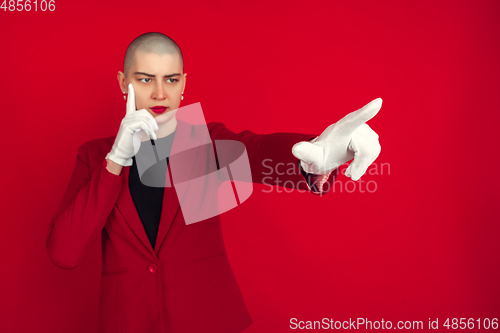 Image of Portrait of young caucasian bald woman on red background
