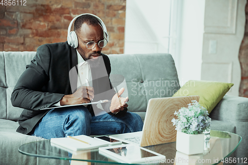 Image of Businessman or student working from home while being isolated or keep quarantine \'cause of coronavirus COVID-19