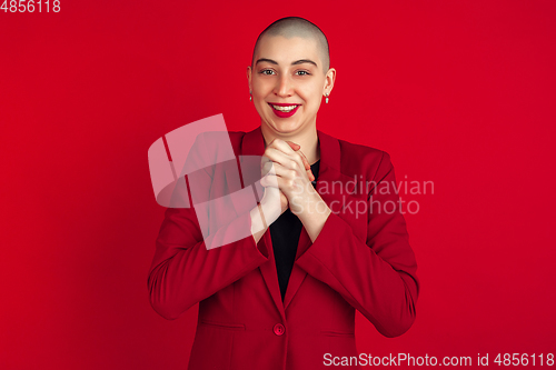 Image of Portrait of young caucasian bald woman on red background