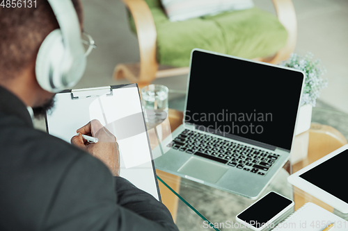 Image of Top view of businessman or student working from home while being isolated or keep quarantine \'cause of coronavirus COVID-19