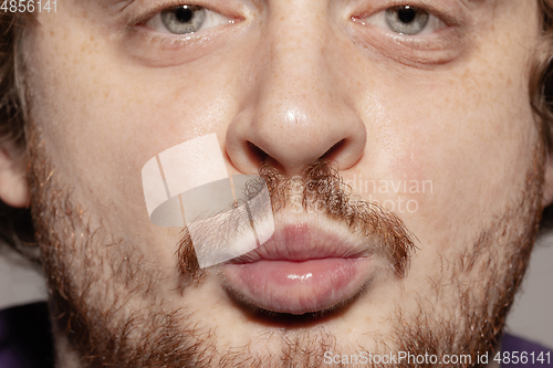 Image of Close-up male mouth illustrating emotions. Cosmetology, dentistry and beauty care, facial expression