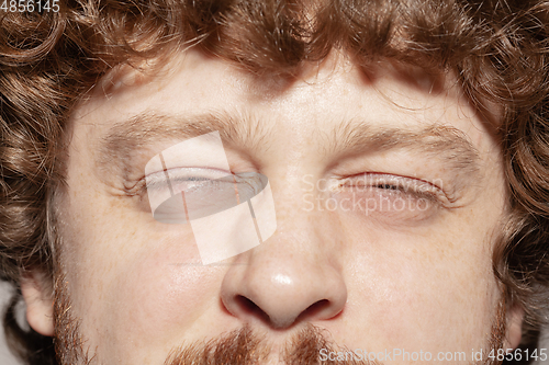 Image of Close up of face of beautiful caucasian young man, focus on eyes