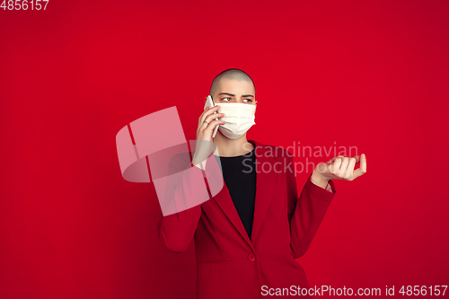 Image of Portrait of young caucasian bald woman on red background