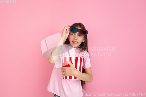 Image of Caucasian little girl portrait isolated on pink studio background, emotions concept