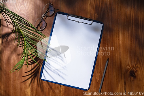 Image of Creative and cozy workplace at home office, inspirational mock up with plant shadows on table surface