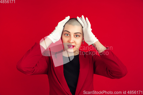 Image of Portrait of young caucasian bald woman on red background