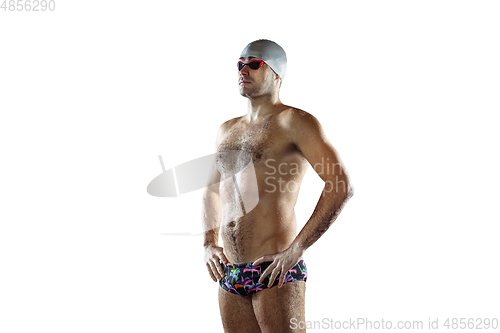 Image of Professional male swimmer with hat and goggles in motion and action, healthy lifestyle and movement concept