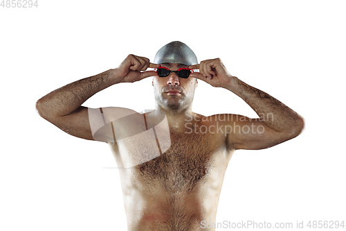 Image of Professional male swimmer with hat and goggles in motion and action, healthy lifestyle and movement concept