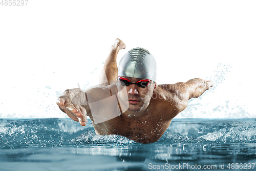 Image of Professional male swimmer with hat and goggles in motion and action, healthy lifestyle and movement concept