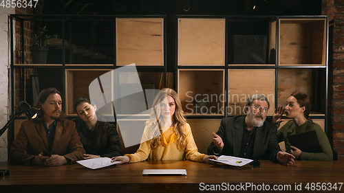 Image of Young colleagues working together in a office styled like classical artworks. Look busy, attented, cheerful, successful. Concept of business, office, finance.