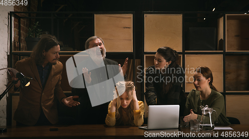 Image of Young colleagues working together in a office styled like classical artworks. Look busy, attented, cheerful, successful. Concept of business, office, finance.