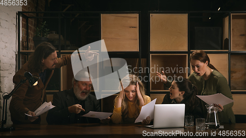 Image of Young colleagues working together in a office styled like classical artworks. Look busy, attented, cheerful, successful. Concept of business, office, finance.